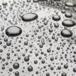 Water beads on super glossy black paint after ceramic coating applied.