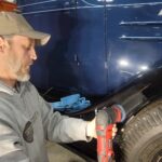 Owner pictured correcting the paint on a 1934 3/4 Ton Chevy Truck.