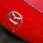 2008 Mazda Miata in for paint correction and ceramic coating decon wash mazda emblem close up