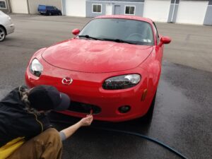 Red 2008 Mazda Miata In for Two Step Correction and Ceramic Coating - Receiving it's decontamination wash